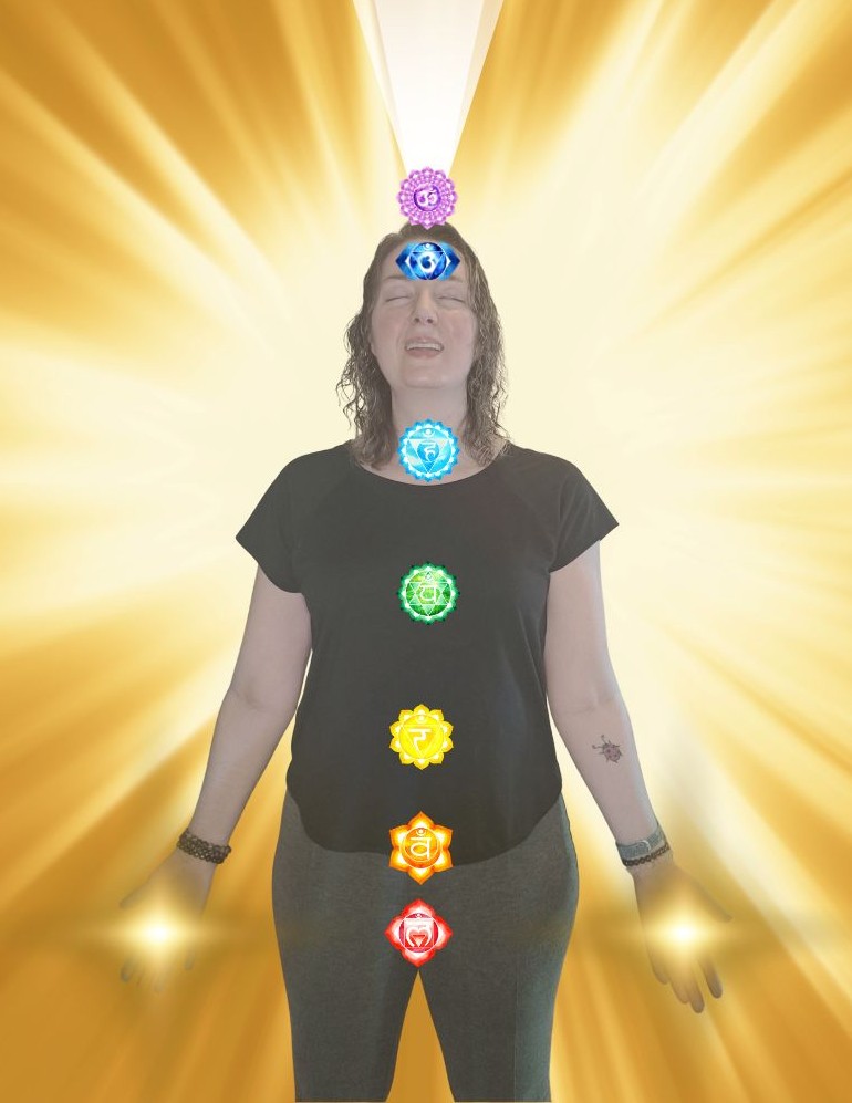 Vanessa standing with golden rays behind her and chakra images down her body
