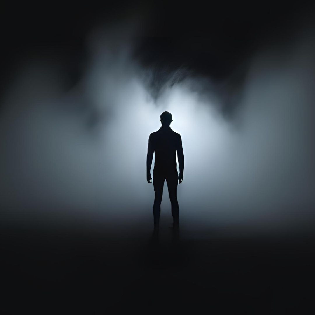figure of person standing in dark fog