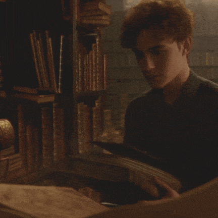 young man flipping through magical book